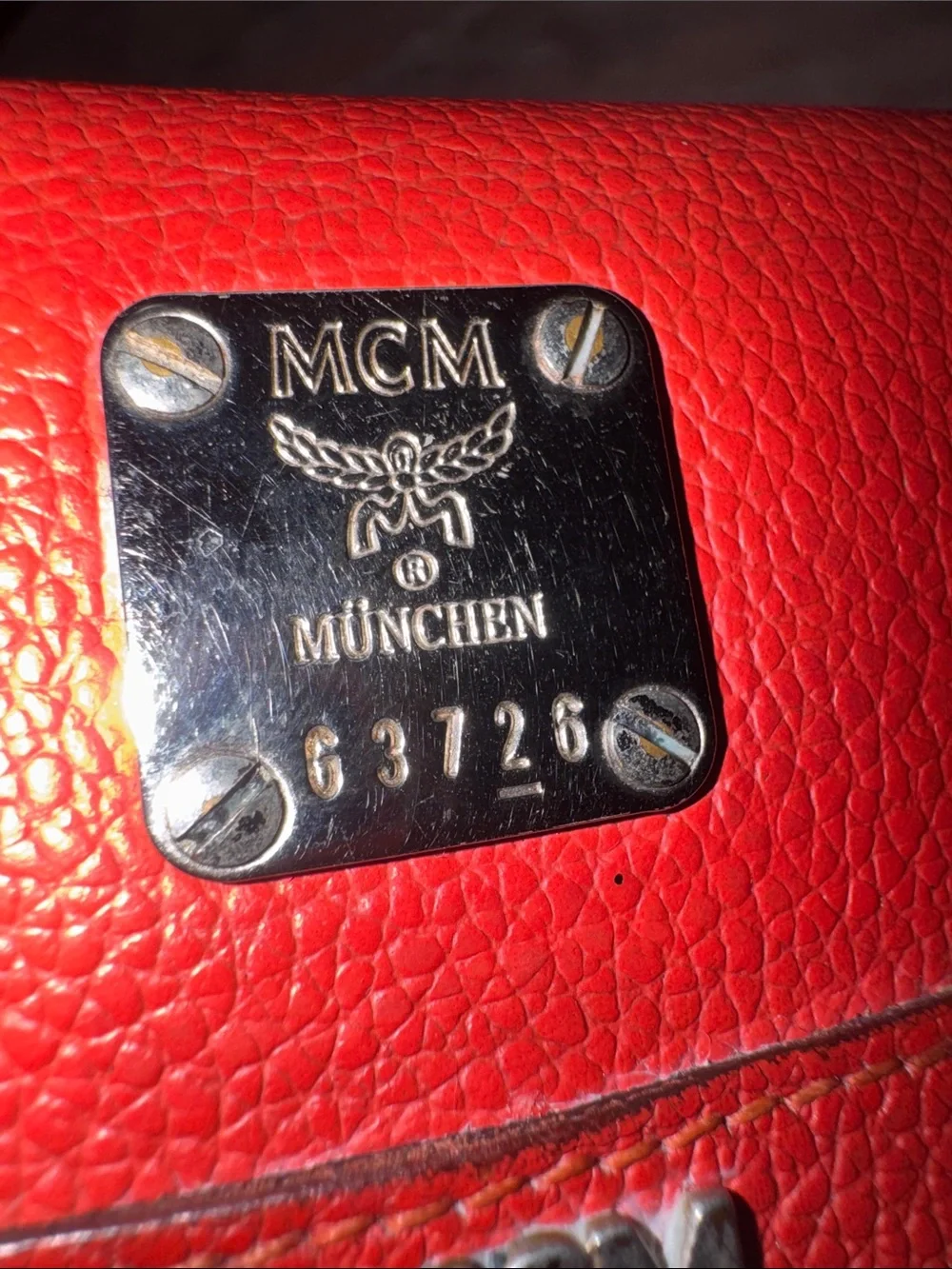 MCM Red Pebbled Leather Fold-Over Wallet.
